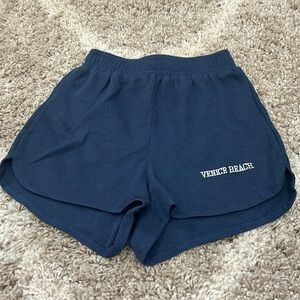 Navy blue casual shorts with white writing “Venice Beach”